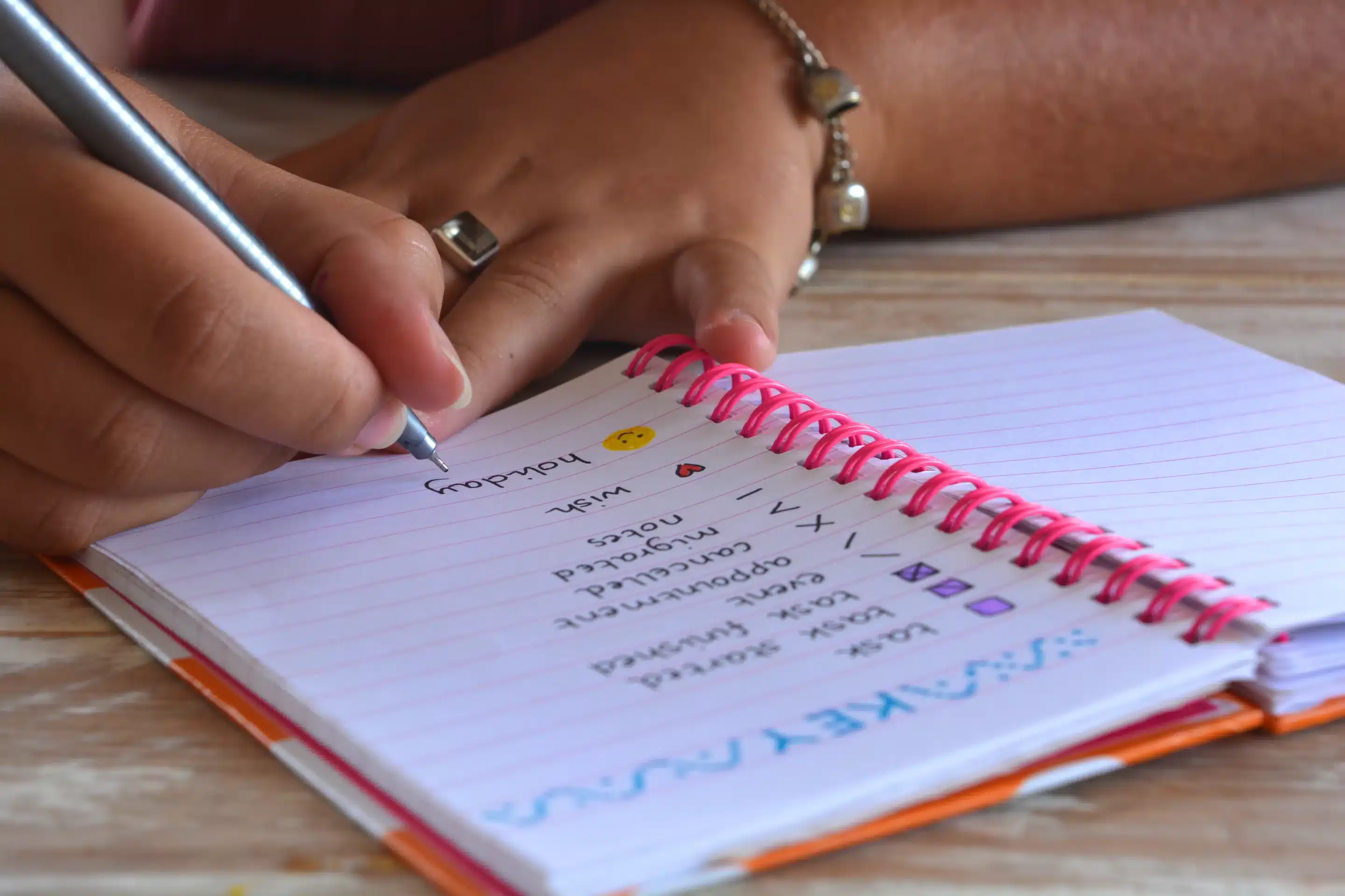 A person writing on a notebook