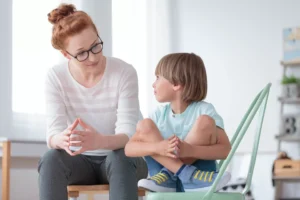 a woman and a boy sitting on a chair