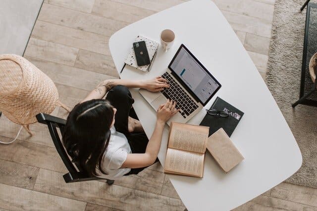 Woman studying and typing in a laptop