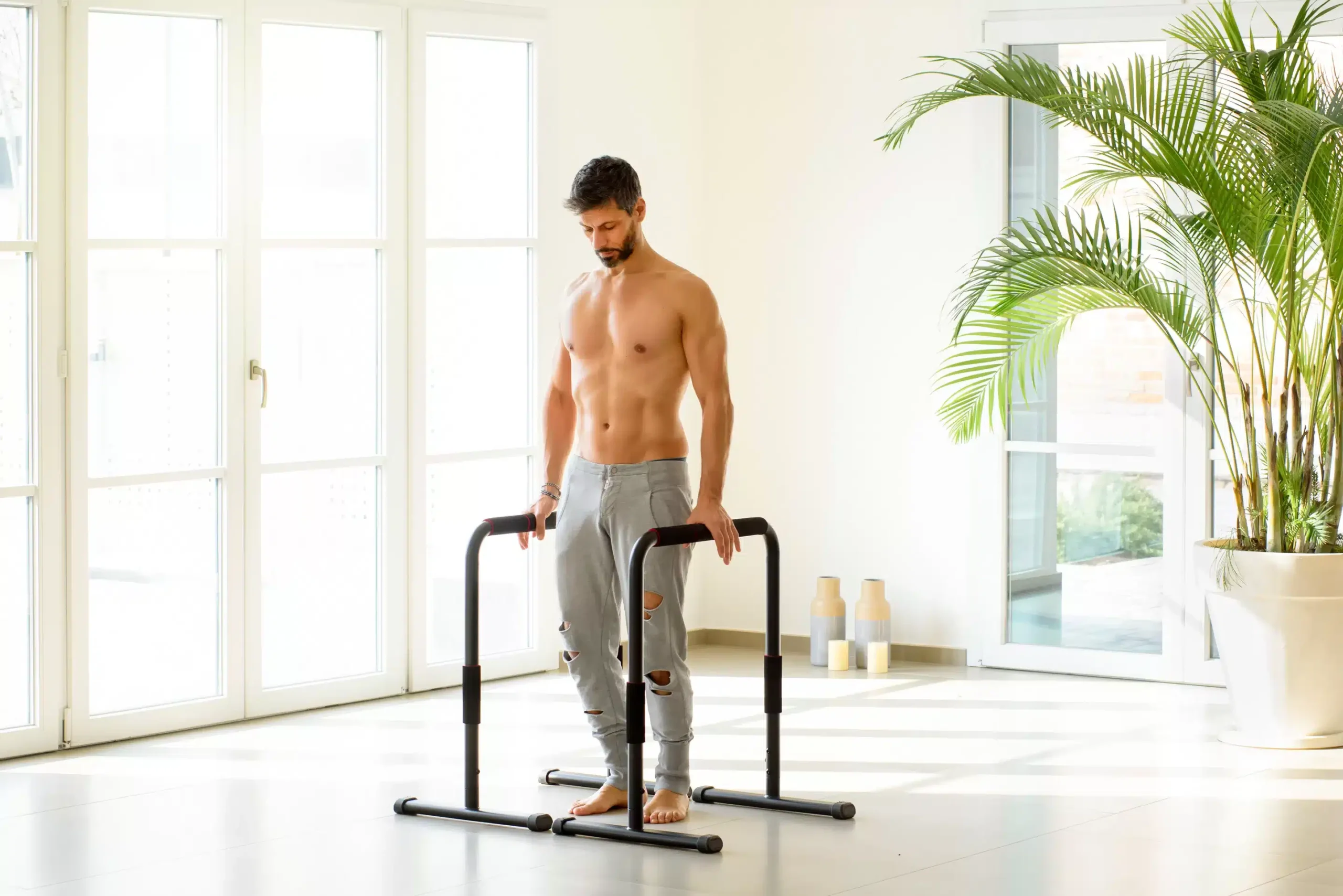a man standing on a pair of black bars