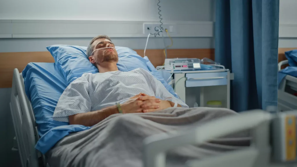 a man lying in a hospital bed