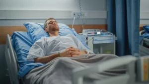 a man lying in a hospital bed