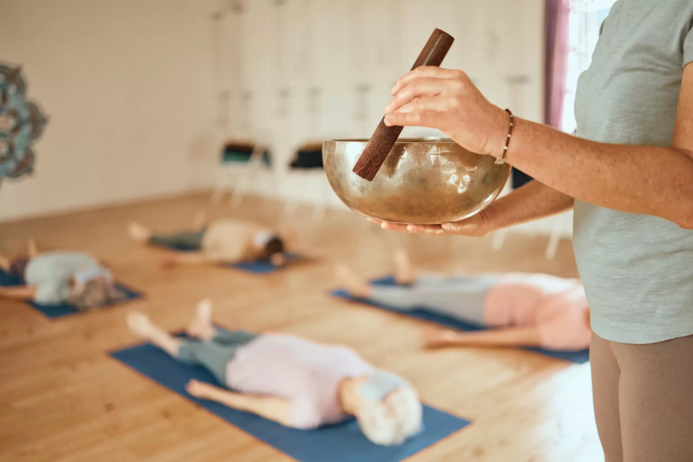 Ketamine Yoga, class and woman with Tibetan singing bowl for meditation, calm and mindfulness in yoga class