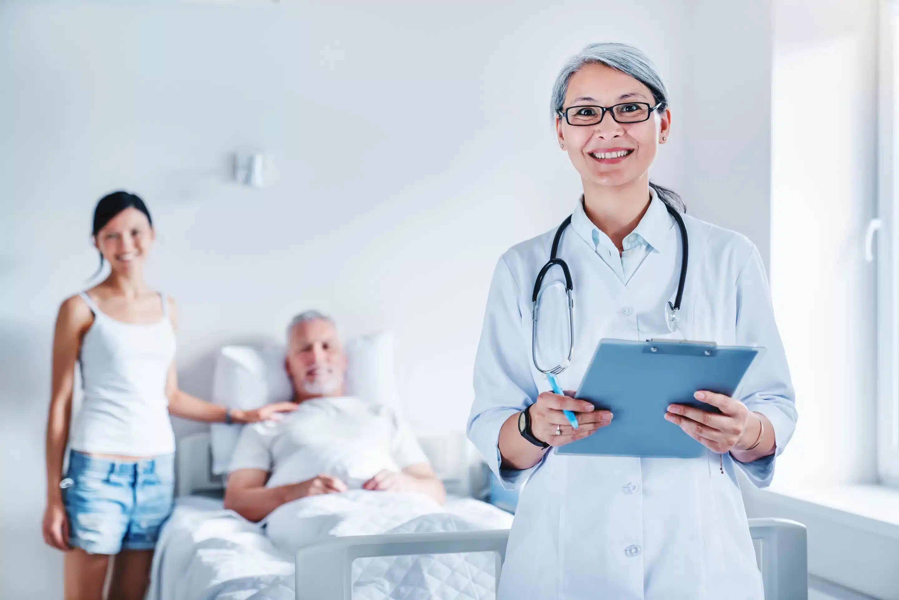 Grandfather, granddaughter and female asian doctor at hospital ward.