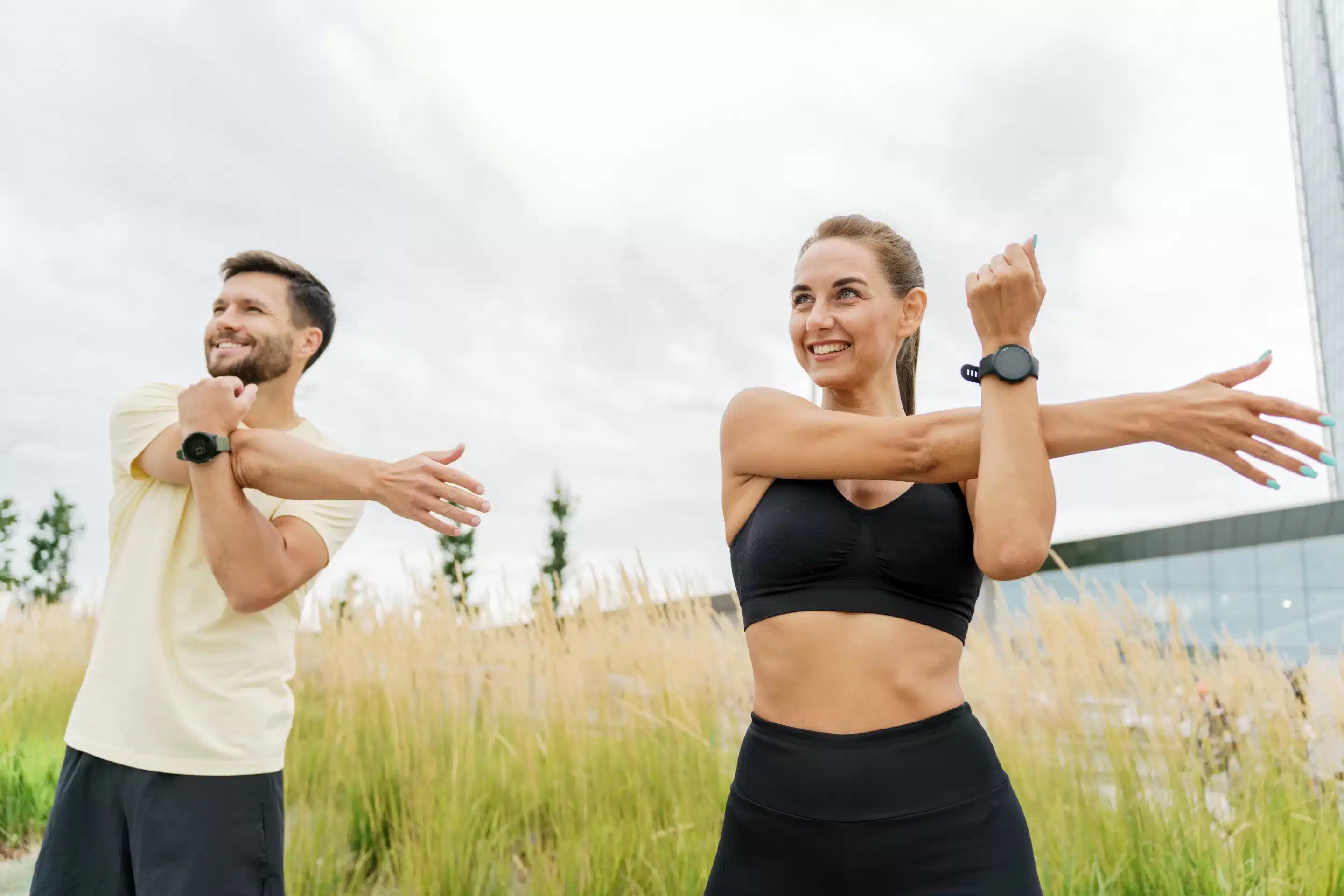 Wearable Devices for Mental Wellness Smiling retired woman stretching legs outdoors. Senior woman enjoying