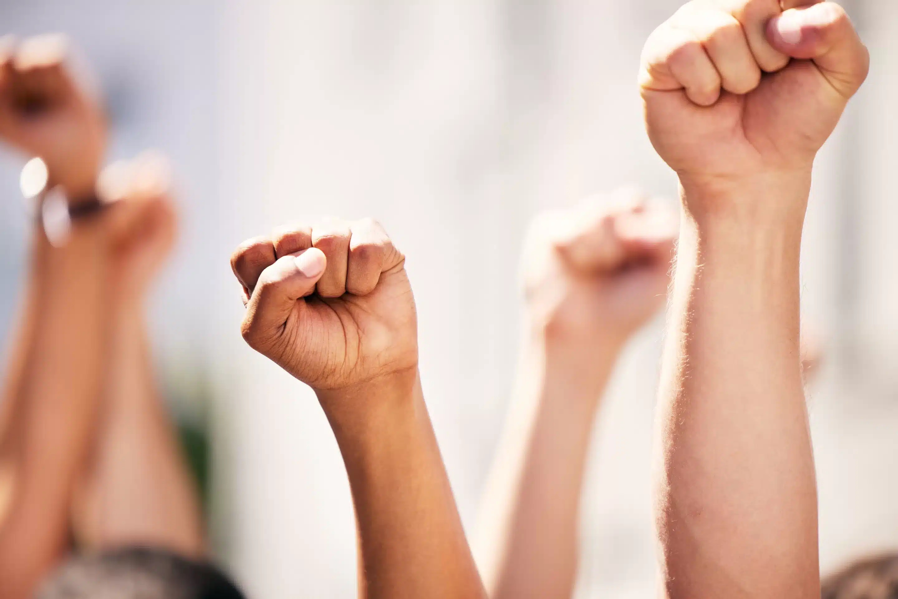 a group of people with fists raised