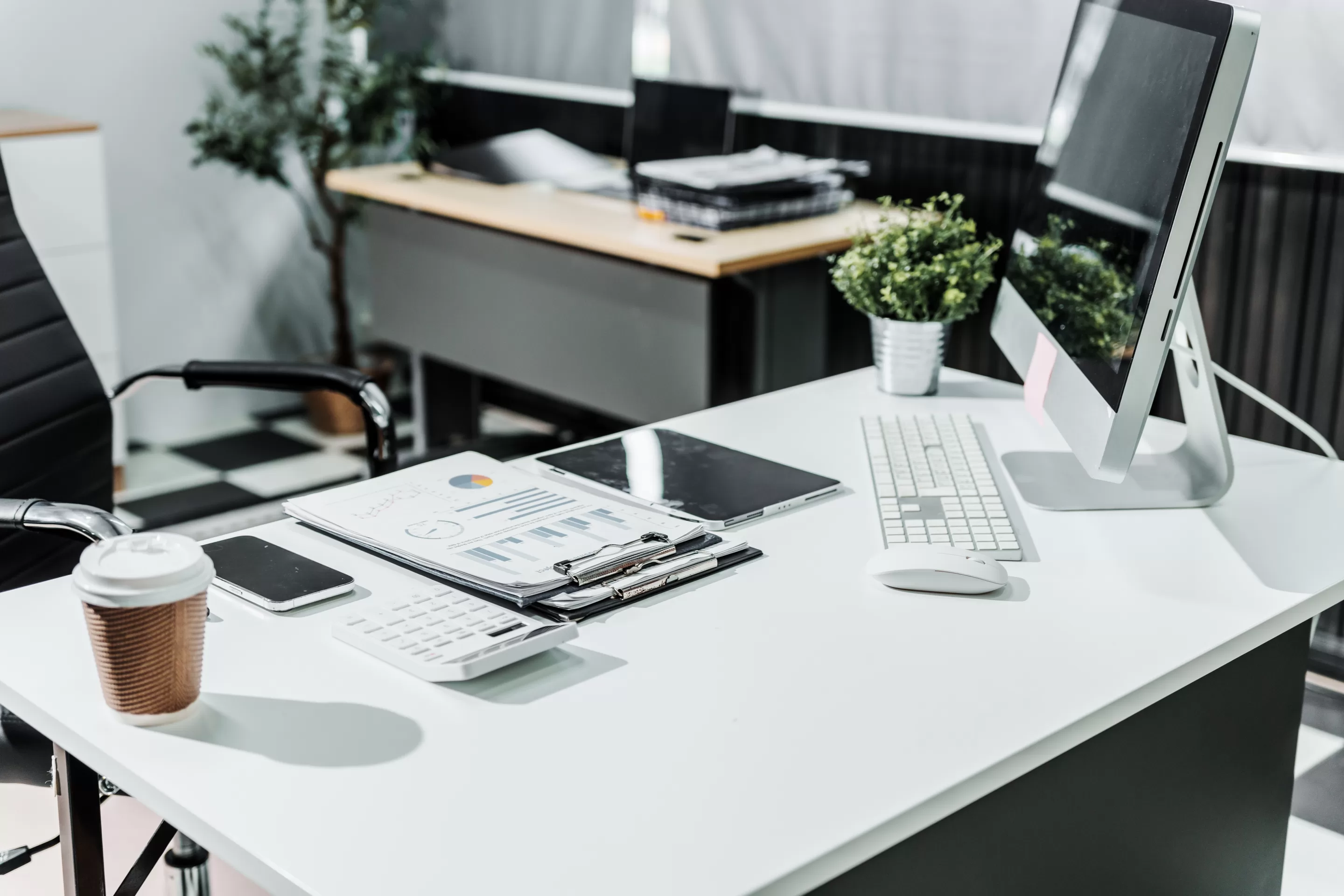 A,Modern,,White-colored,Business,Office,With,A,Wooden,Desk,,Calculator, Shared office space available for rent and lease