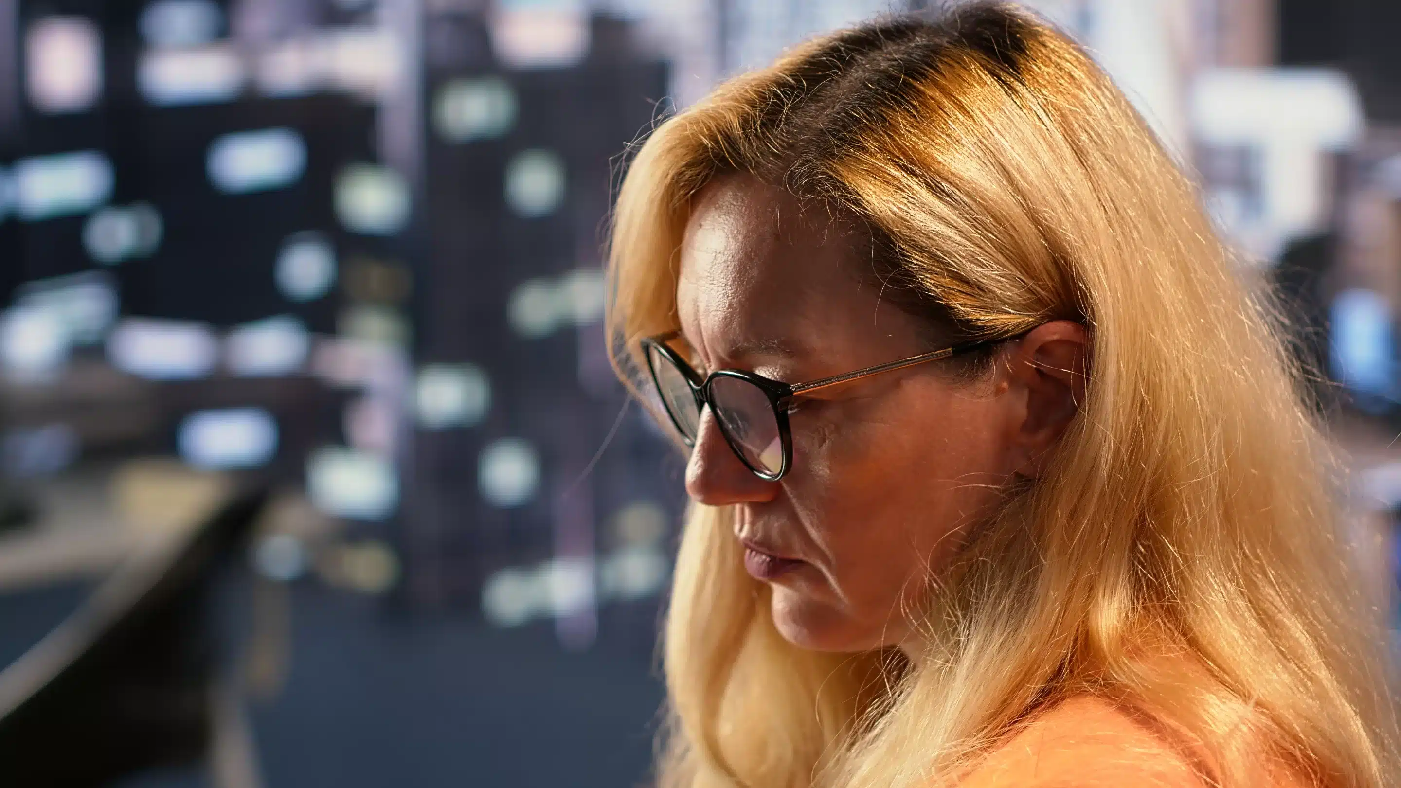 a woman with glasses looking down