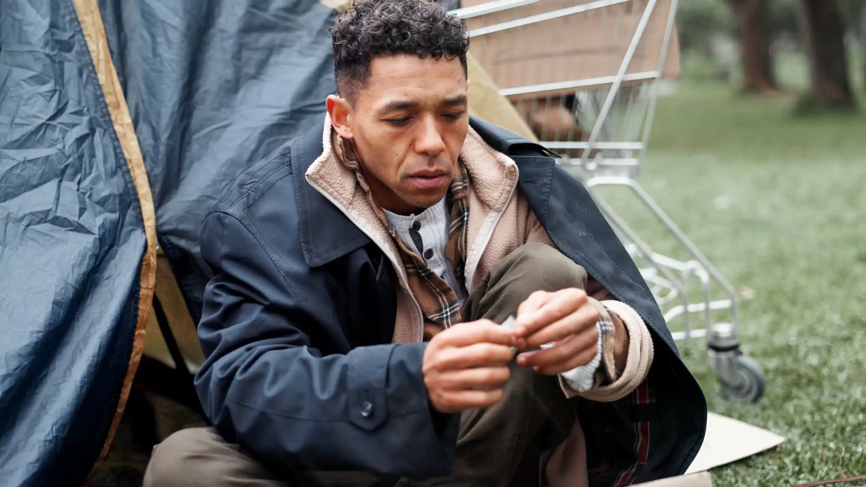 Ketamine Man, poverty and homeless with drugs at park, package and thinking with illegal product by tent in winter