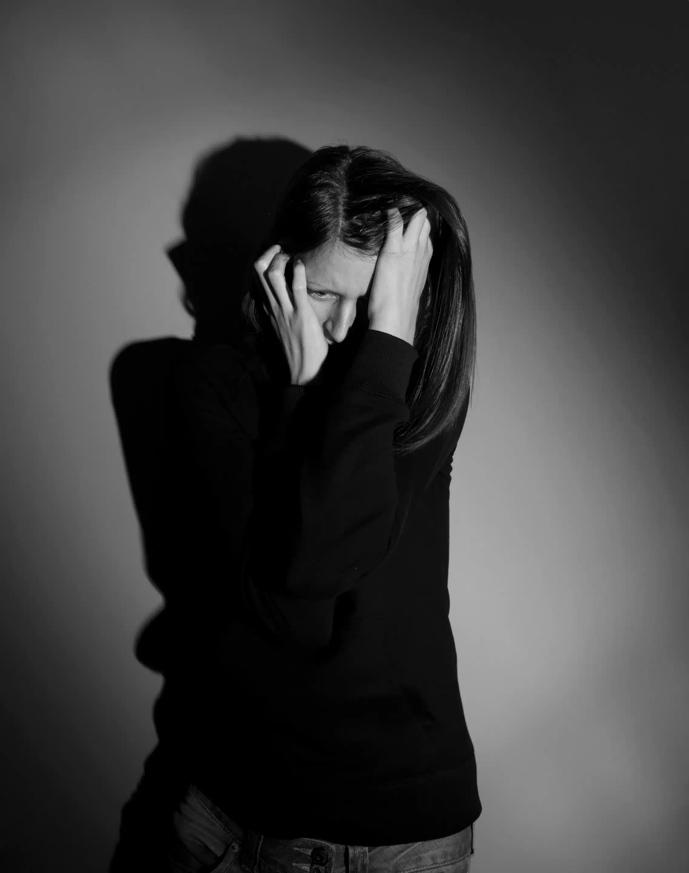 a woman holding her head with her hands