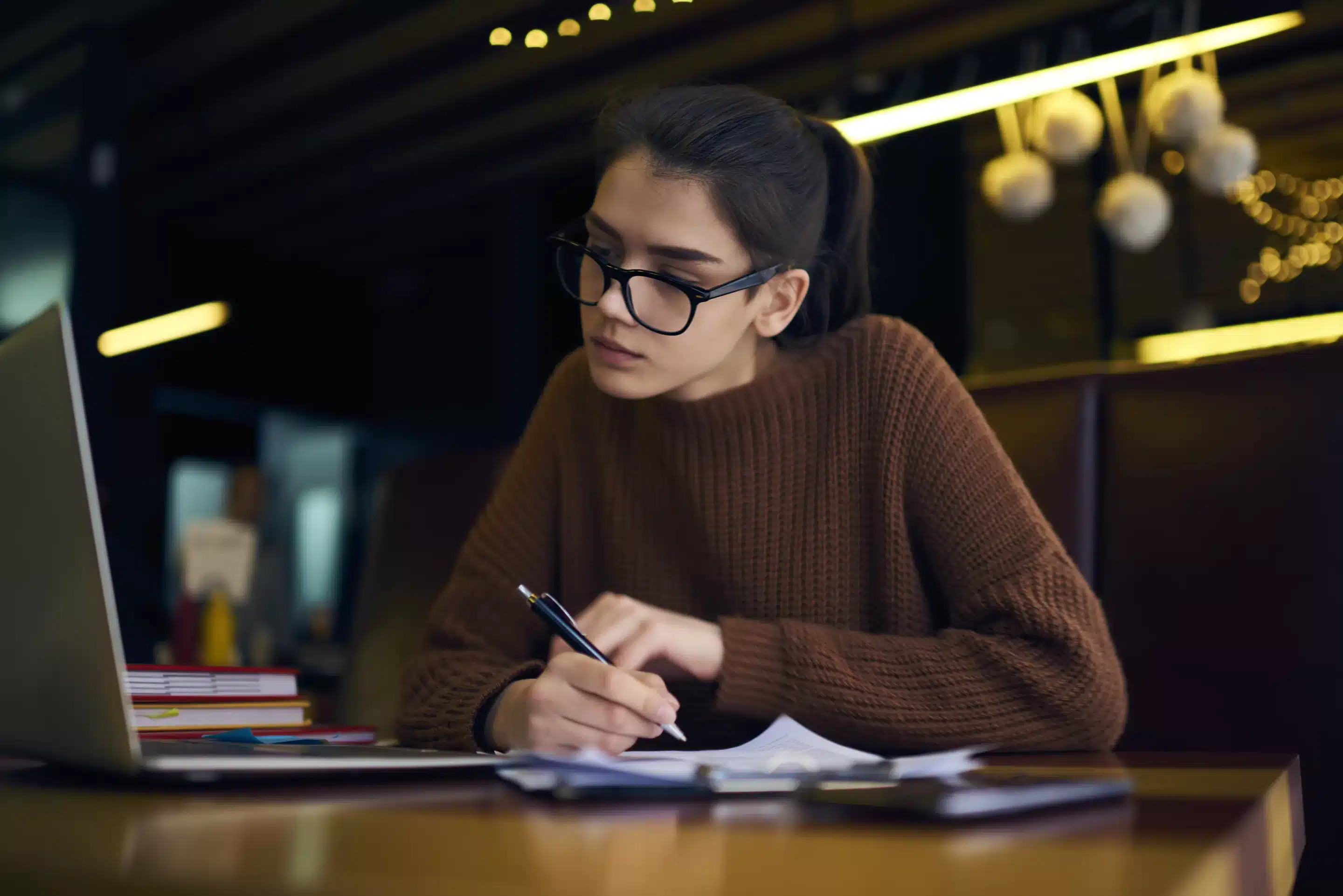 a woman writing on paper
