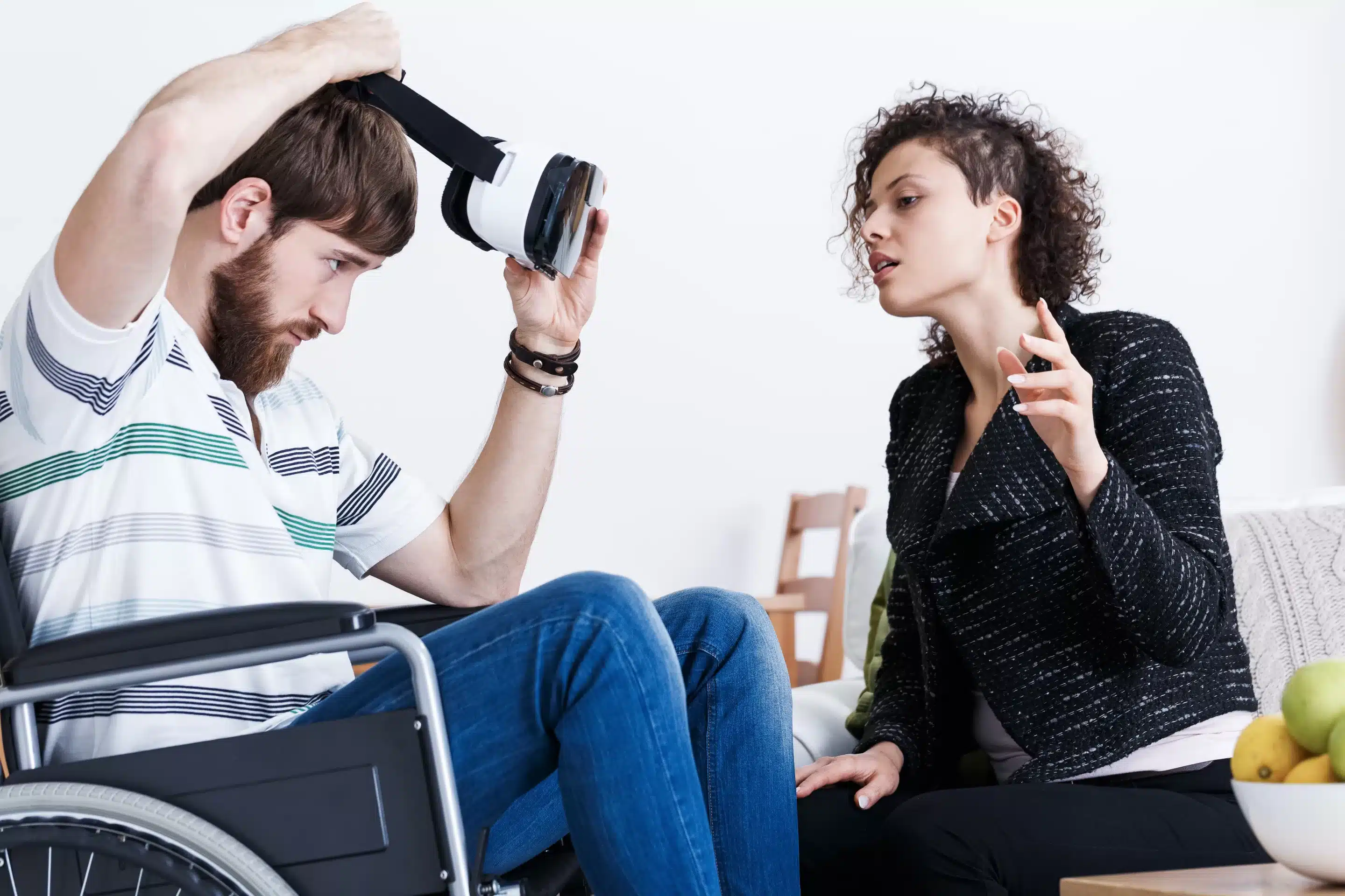 Young man in wheelchair testing virtual reality technology 
