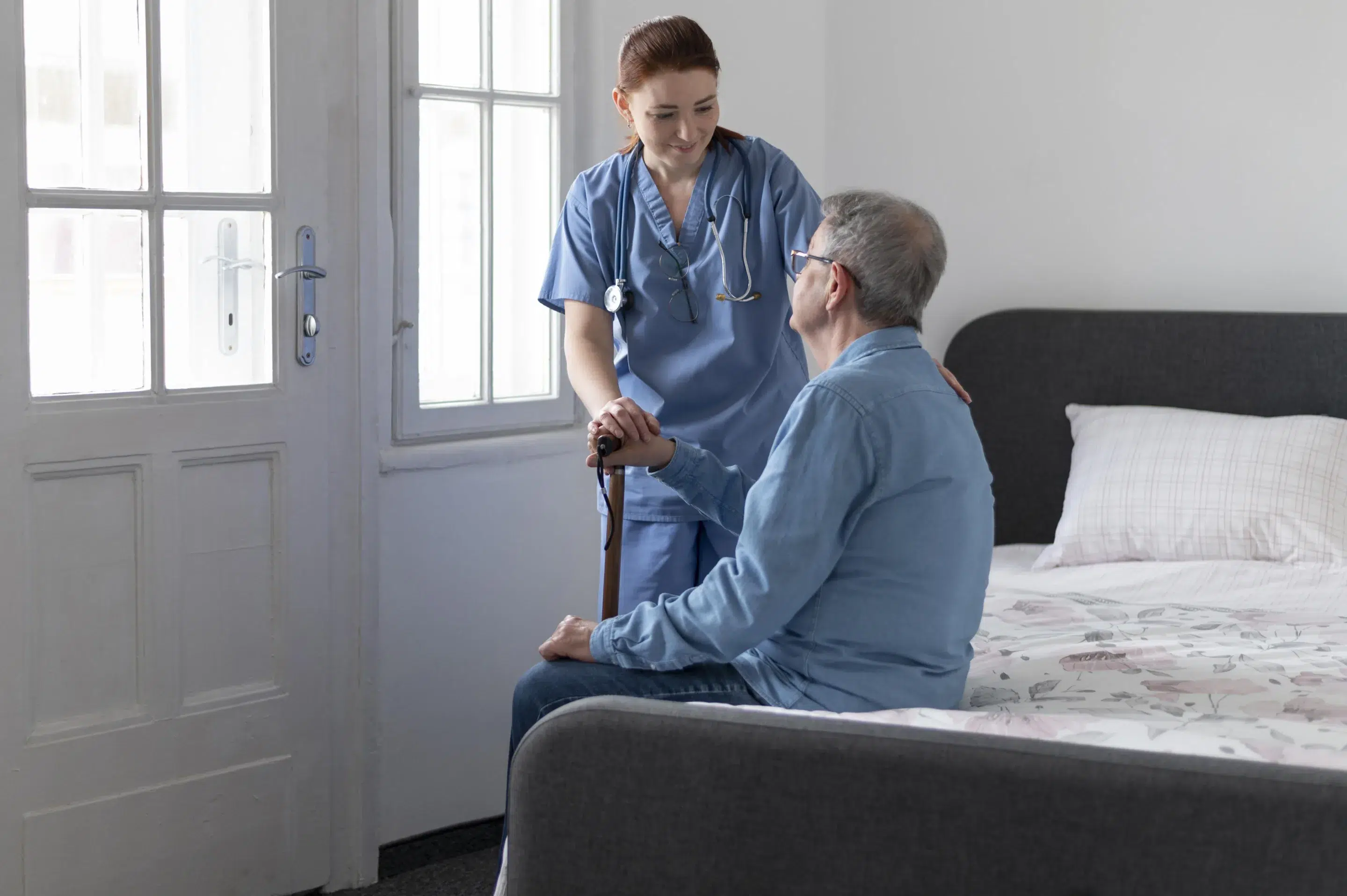 Nurse performing a health check on an elderly man during a medical examination